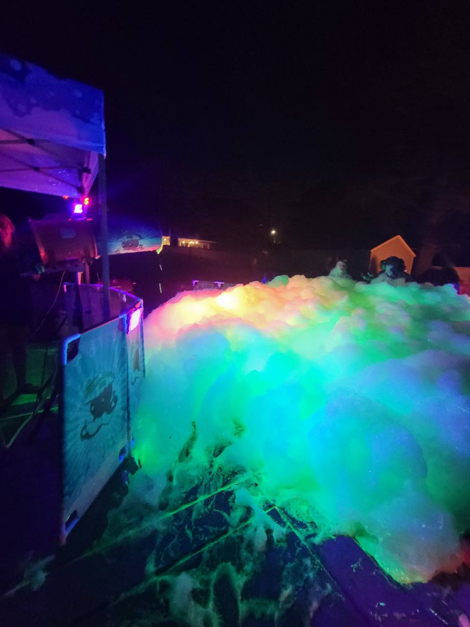 Neon foam illuminated by colorful blacklights during a Glow Foam Night Party