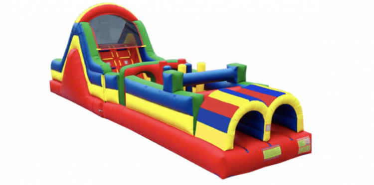 Red, yellow and blue inflatable obstacle course with a tall slide