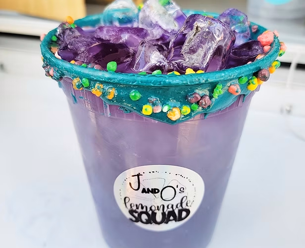 Purple iced drink with a candy-decorated rim